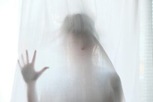 Girl touching a shower curtain